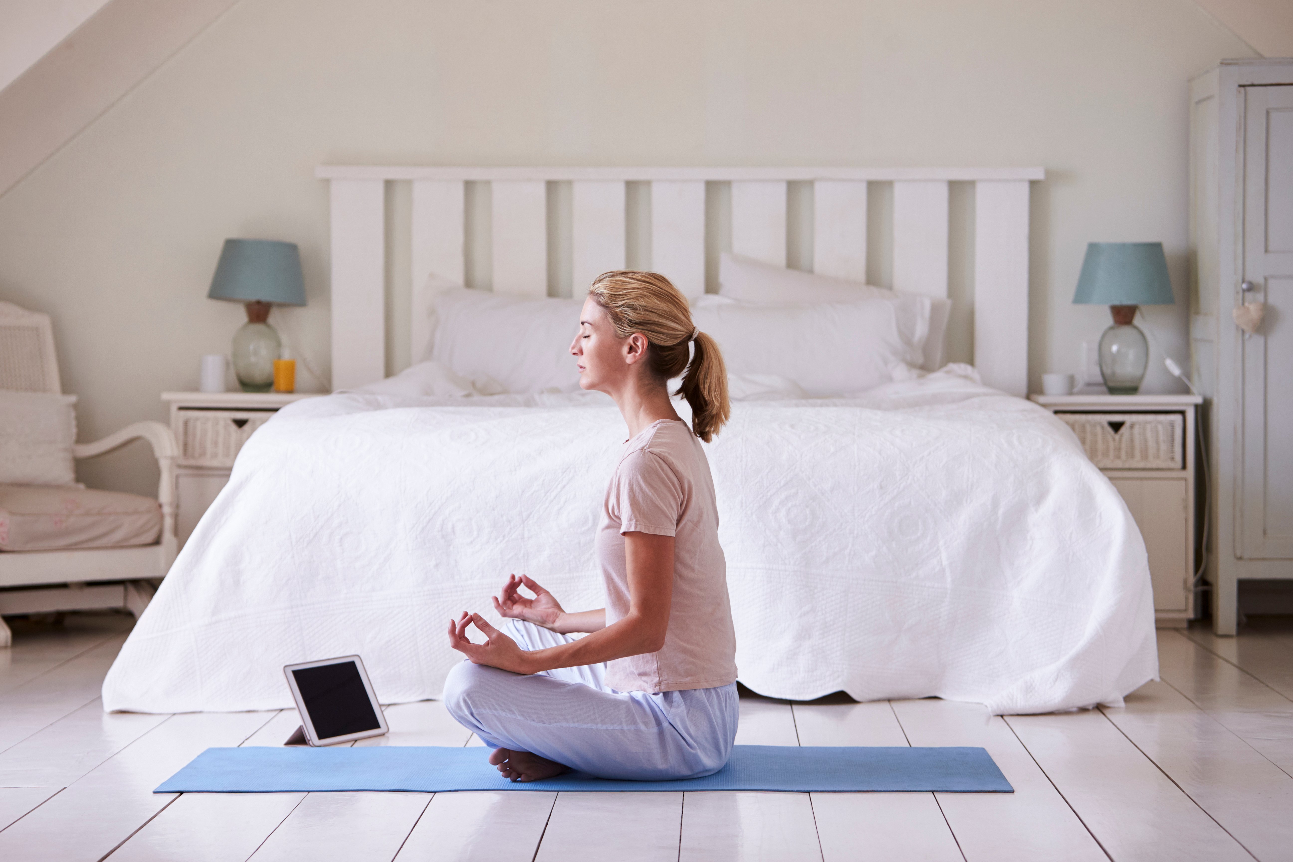 Canva - Woman with Digital Tablet Using Meditation App in Bedroom